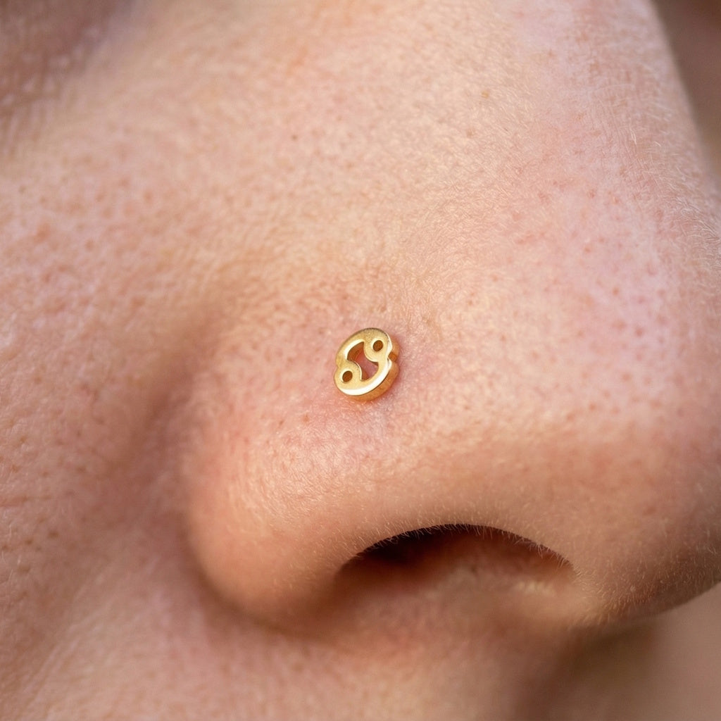 Cancer gold surgical steel zodiac nose stud on model.