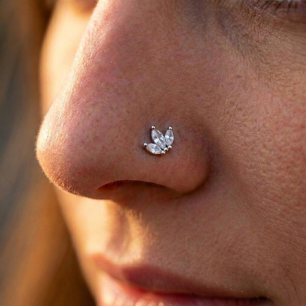 CZ Marquise Leaf Fan L Bend Nose Stud 20G 1/4" 316L Surgical Steel Nose Ring In Silver in the nostril of a person's nose.