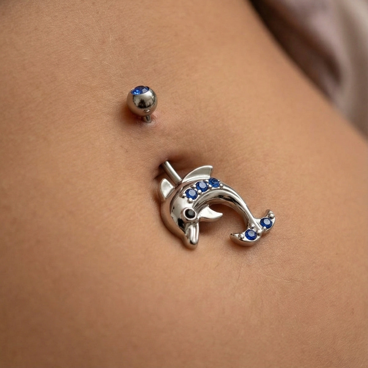 Dolphin Blue CZ Belly Ring 14G 316L Surgical Steel on female model.