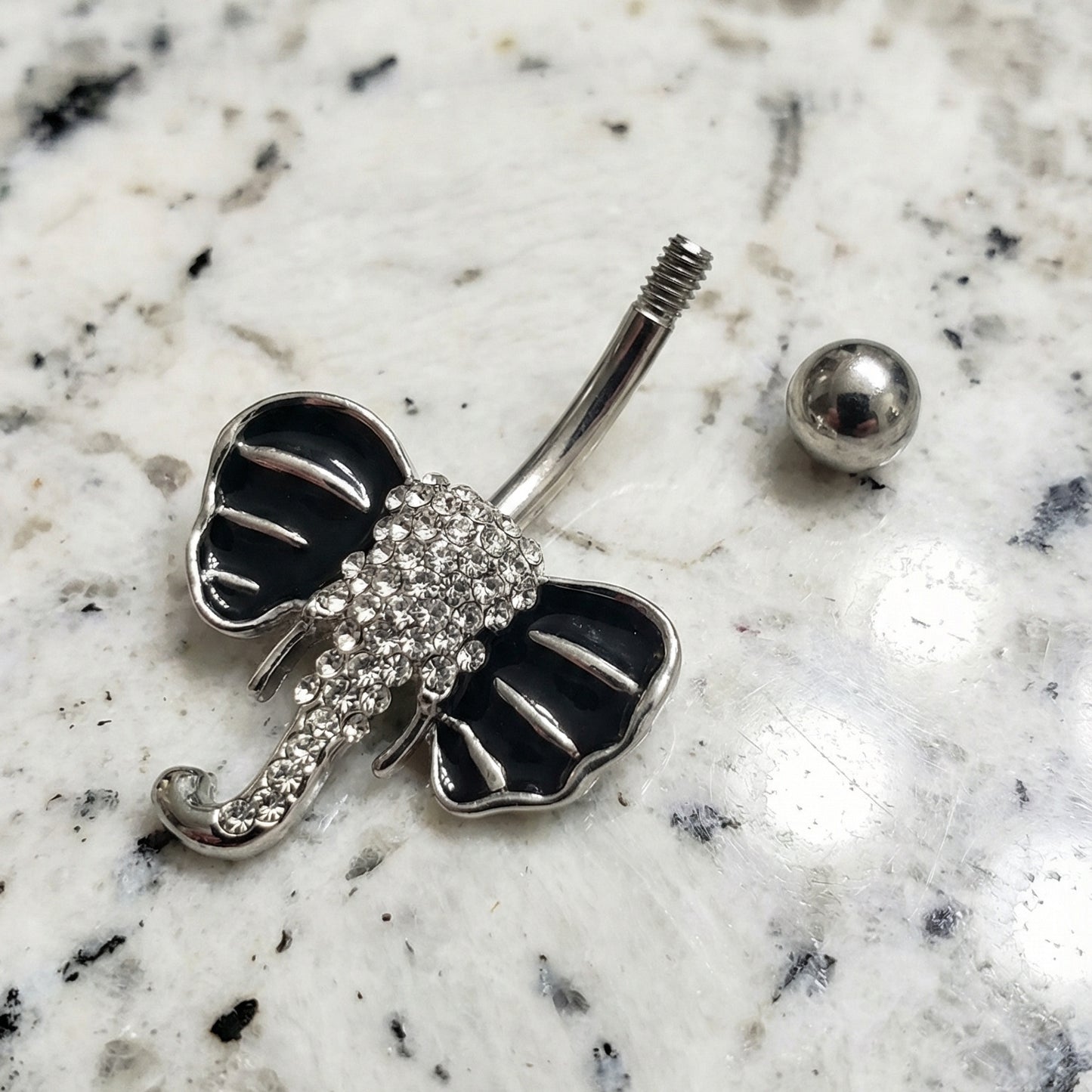 Elephant belly button bar pictured on a white granite countertop.