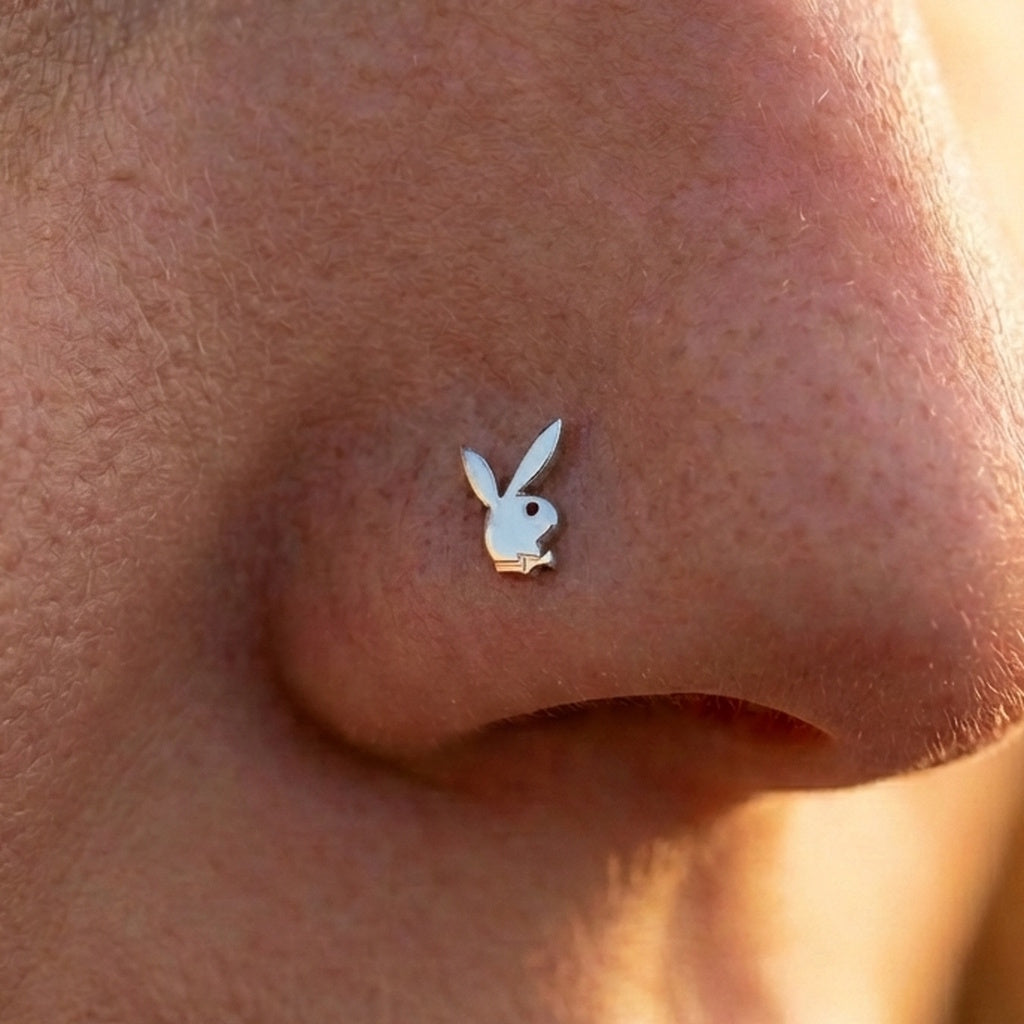 Silver playboy nostril ring on the nose of a model.