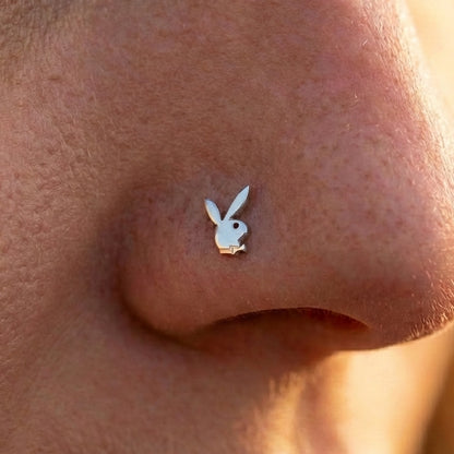 Silver playboy nostril ring on the nose of a model.