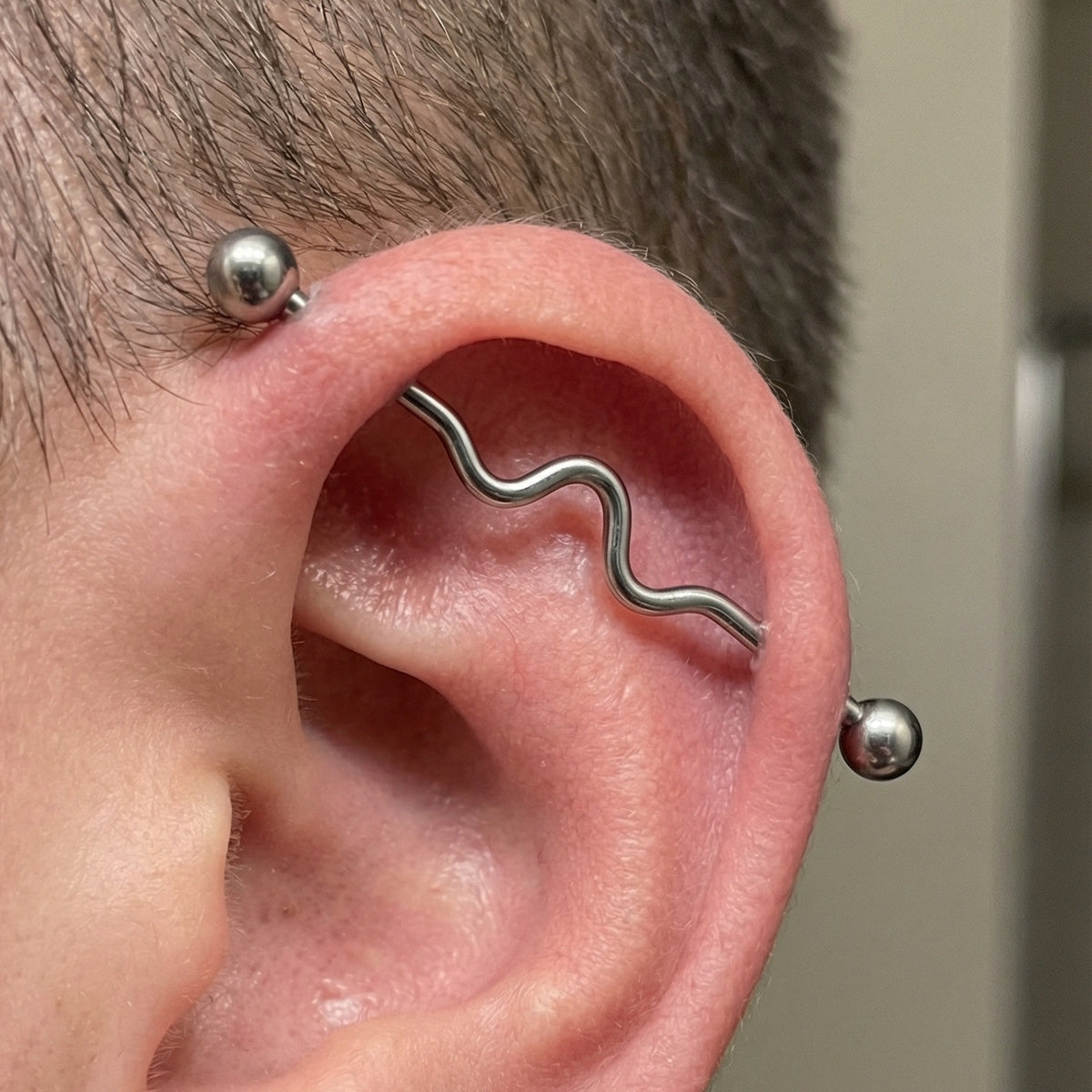 Wavy Industrial Barbell 14G 316L Surgical Steel Left Ear.